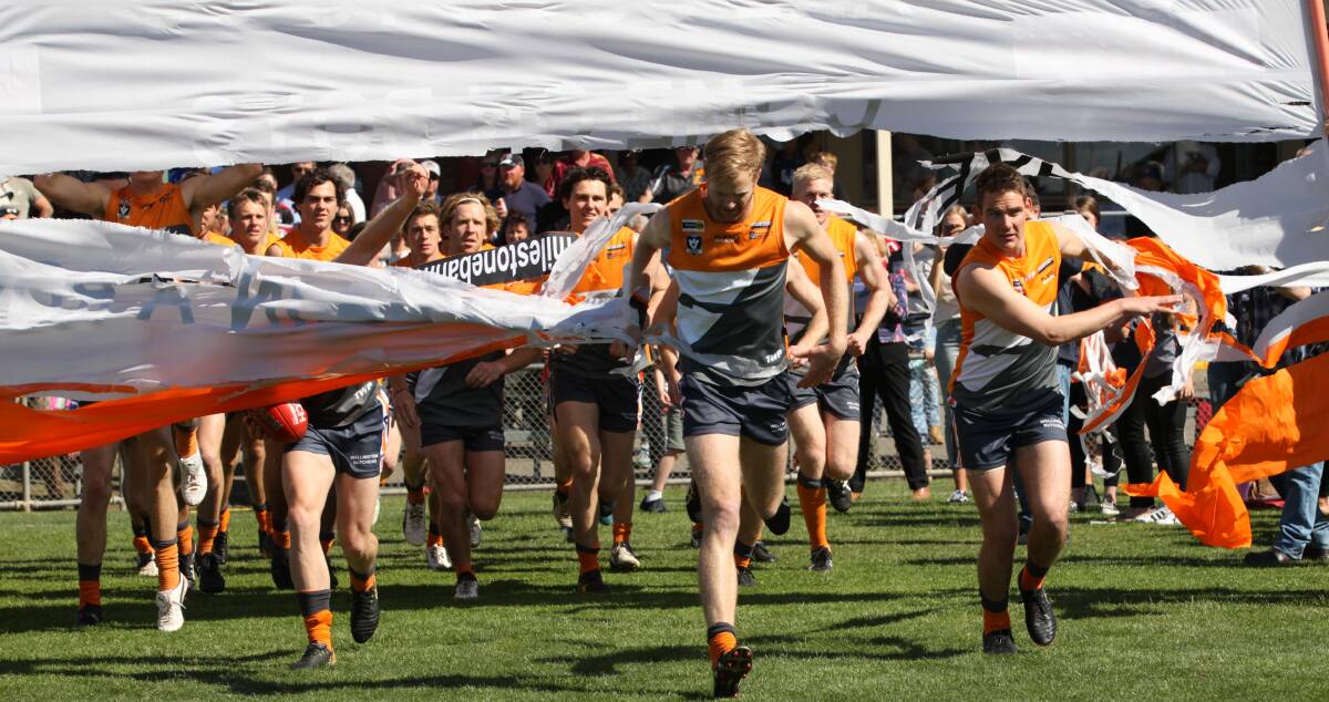 The Giants run out onto Anzac Park for the senior grand final. 