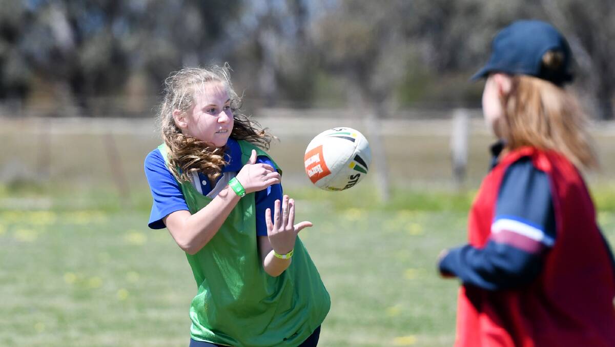 Holy Trinity Lutheran College student Chanel Scollary makes a quick pass during a Touch Gala Day run by Touch Football Victoria in October.