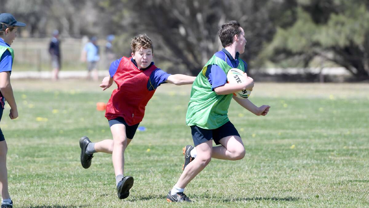 Holy Trinity Lutheran College students Zac Dufty chases down Colby Wilde, during a Touch Gala Day run by Touch Football Victoria in October. 
