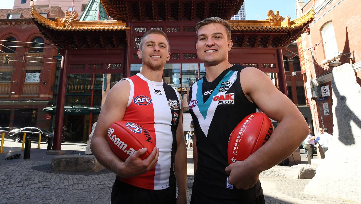 EXCITED: Former Horsham footballer Seb Ross of St Kilda with Port Adelaide's Ollie Wines at Little China Town in Melbourne. They will play in China next season. Picture: AAP 