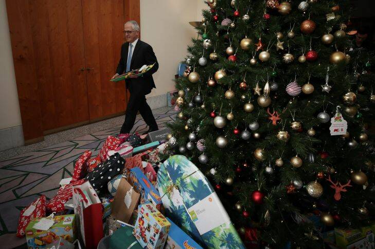 Prime Minister Malcolm Turnbull helps load the van with gifts from the Kmart wishing tree at the Prime Minister's office at Parliament House in Canberra. Photo: Alex Ellinghausen