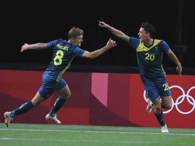 Lachlan Wales (r) reacts after his opening goal as the Olyroos shocked Argentina at the Olympics.