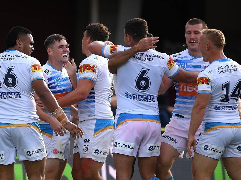 AJ Brimson (2-l) is congratulated after scoring a try for the Titans in their NRL win over Manly.