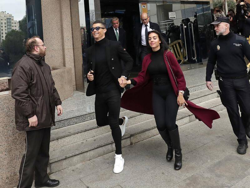 Cristiano Ronaldo leaves the court in Madrid after striking a deal over tax fraud charges.