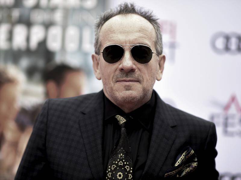 Elvis Costello says he feels 'right as rain' after his cancer operation.