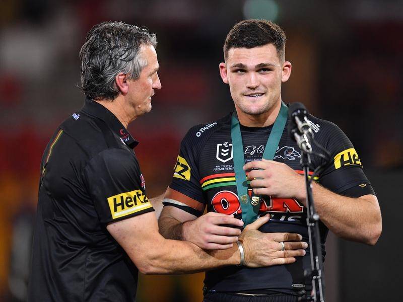 Nathan Cleary (r) was presented with the Clive Churchill Medal by his father and coach Ivan Cleary.