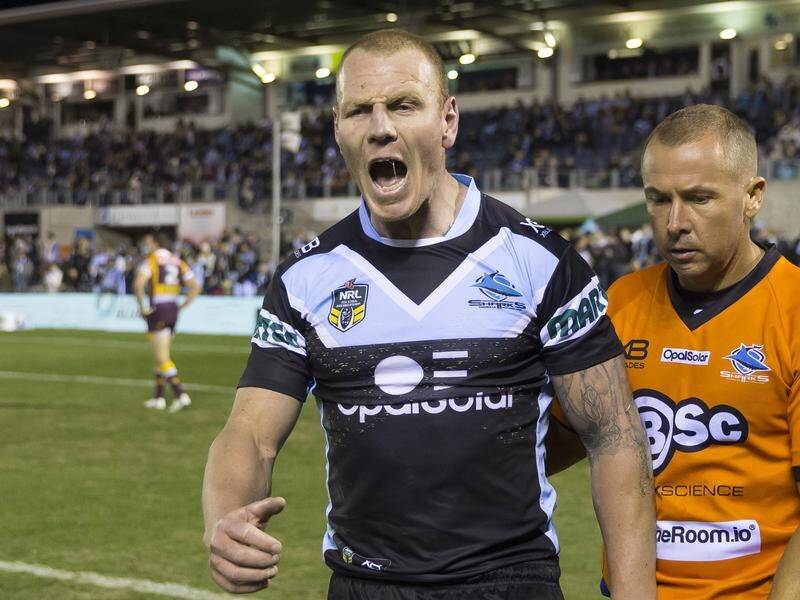 Cronulla coach Shane Flanagan says his Sharks players were shocked by Luke Lewis's retirement.