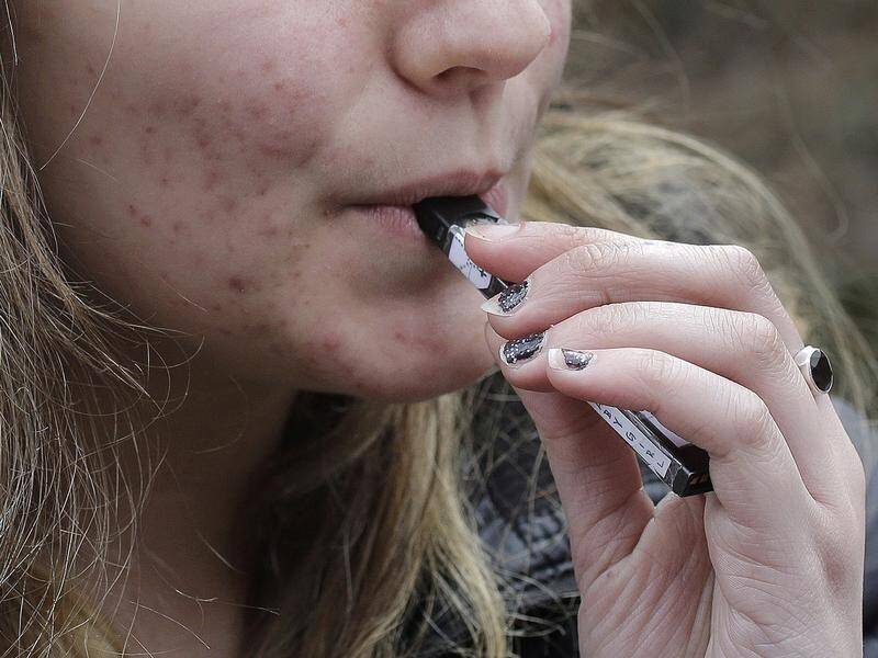 Students are holding the smoke in their lungs to try to avoid vaping detectors in schools. (AP PHOTO)