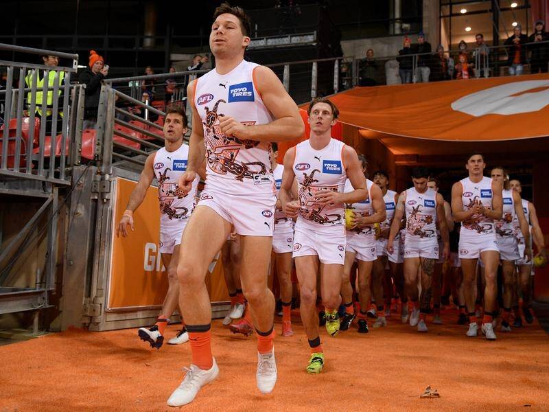 GWS superstar Toby Greene leading out the Giants before their hammering of Carlton.