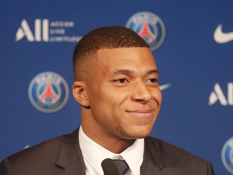 A smile worth A$7m-a-month? Kylian Mbappe discusses his decision to stay at hometown Paris SG.