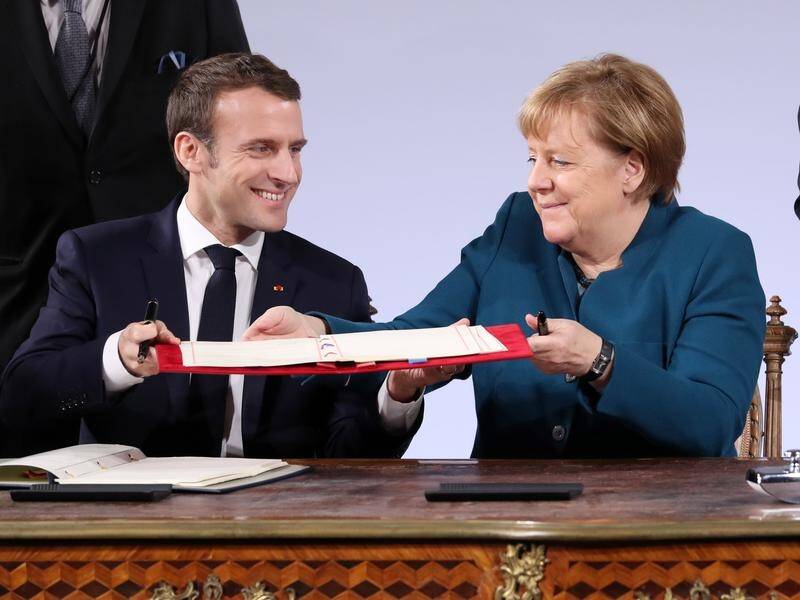German Chancellor Angela Merkel (R) and French President Emmanuel Macron have signed a treaty.