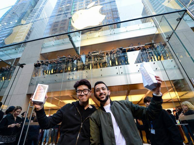 Teddy Lee (R) and Mazen Kourouche are among the first customers to buy new Apple products in Sydney.