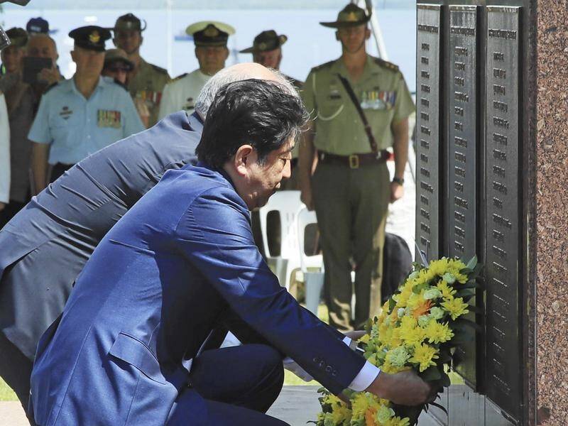 Shinzo Abe has paid his respects to Australia's fallen in Darwin.