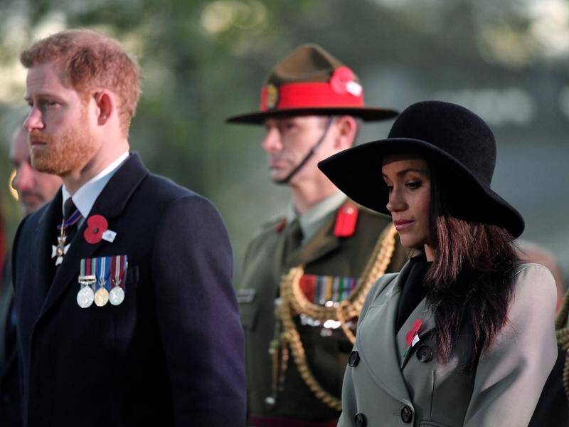 Prince Harry and fiancee Meghan Markle have attended the Anzac Day dawn service in London.