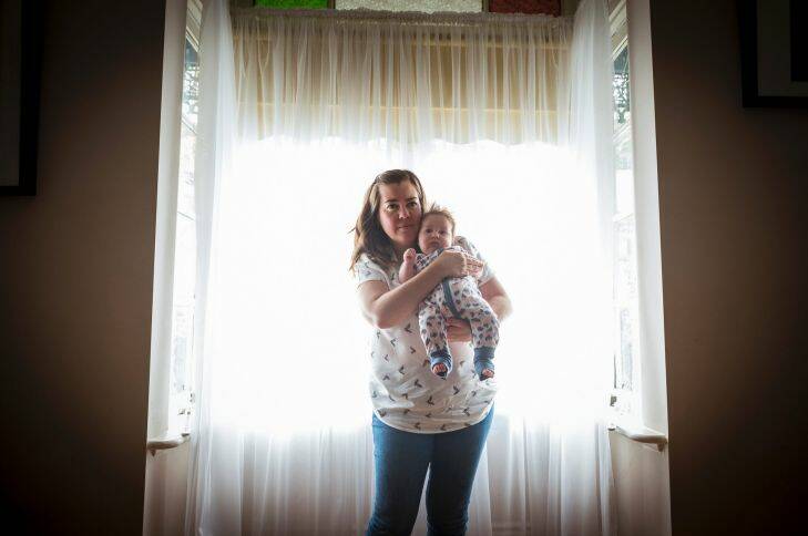 Kim Hutchinson embraces her 3 month old daughter Celia who suffers from colic daily.. Photo: Chris Hopkins