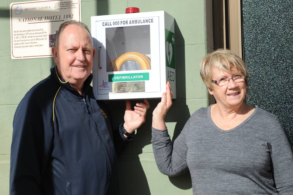 FOR THE COMMUNITY: Natimuk's National Hotel licensees Bill and Anne Lovel with the donated defibrillator installed at the front of the hotel. Picture: SONIA SINGHA
