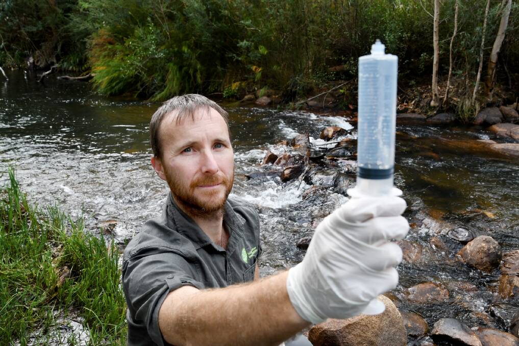 WILDLIFE CONSERVATION: Ecologist and researcher Josh Griffiths holding a water sample collected from the McKenzie River. The sample will be tested in Melbourne labs for platypus DNA. Picture: SAMANTHA CAMARRI