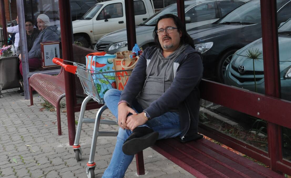 CALL FOR IMPROVEMENT: Horsham man Brett Heinrich waits for the last bus service of the day at Coles in Horsham. He uses the bus service every day. Picture: SONIA SINGHA