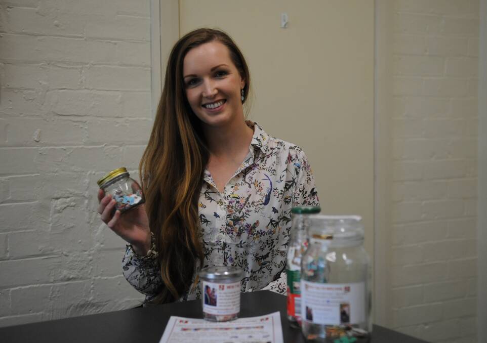 CHARITY JAR: Kirsten Ridgeway showing her collection of breadtags at her workplace. Picture: SONIA SINGHA