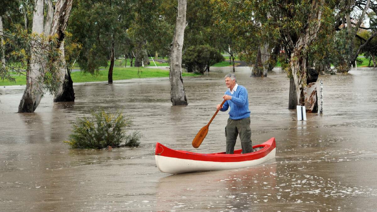 RAINY DAYS: Keith Lockwood paddles down the swollen Natimuk Creek at Natimuk on Wednesday. Picture: PAUL CARRACHER 