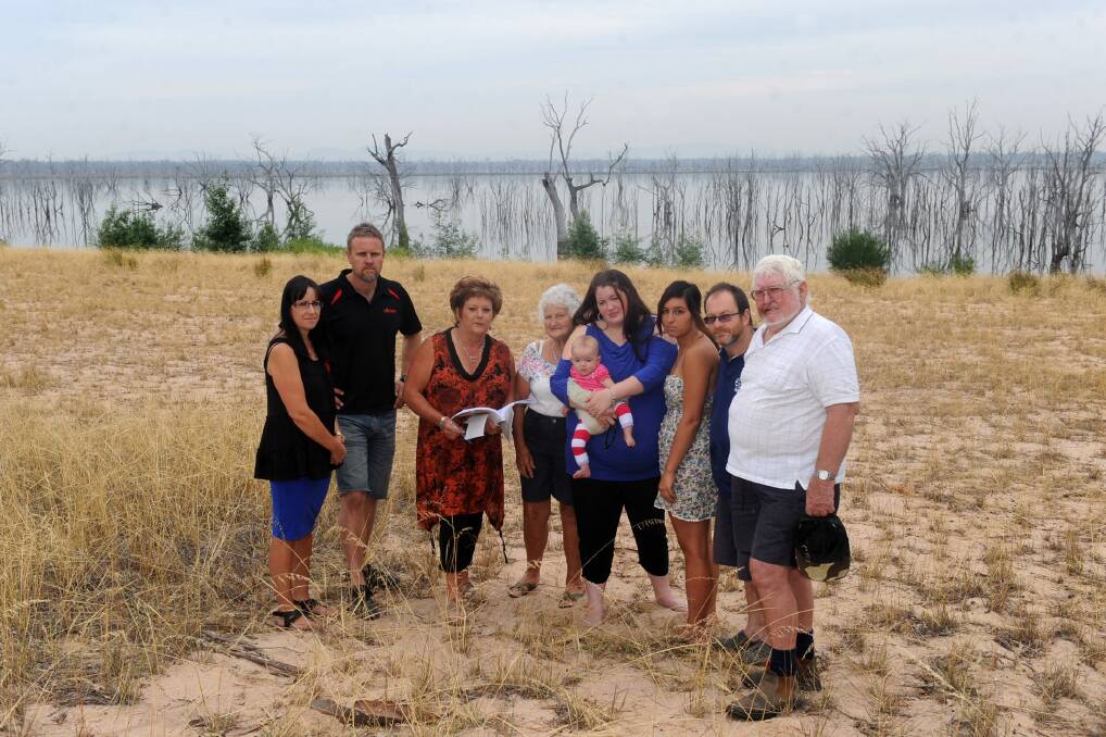 TOWN CRY: Toolondo residents Simone and Jay Miller, Carmel Ofﬁcer, Maggie Smith, Trixie Sampson and her daughter Isabel Lane, Tash Mustafa, Ewan 
McDonnell and Hugh Smith in front of Toolondo Reservoir. Picture: SAMANTHA 
CAMARRI
