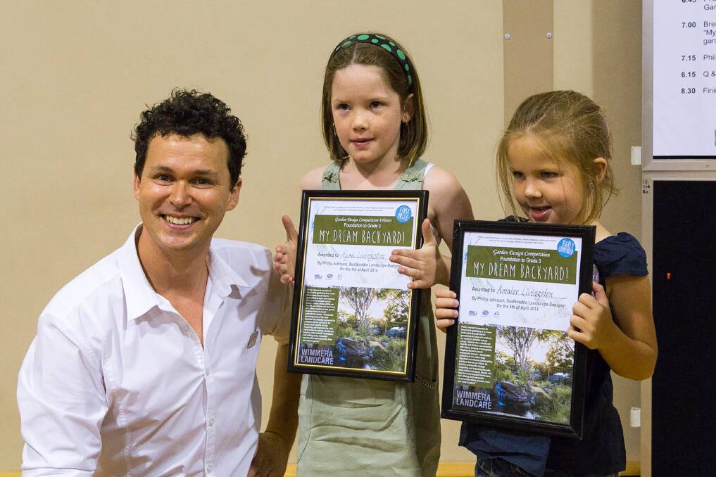 YOUNG DESIGNERS: Chelsea Flower Show-winning landscape designer Phillip Johnson congratulates sisters Kyah and Amalee Livingston on their success in the foundation to grade three section of the garden design competition. 