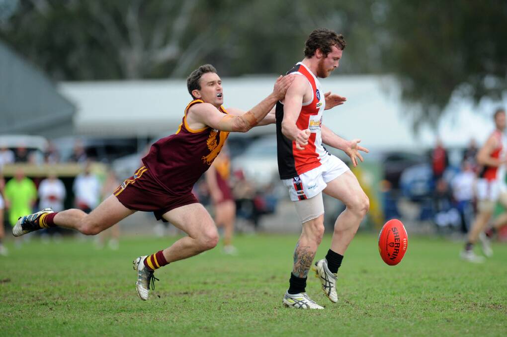DESPERATION: Ben Harrison tackles Horsham Saint Pat Knott. Harrison captained the Warrack Eagles in 2014 but will cross to Horsham District league club Kalkee next season as an assistant coach. Dimboola's Matt Magee will also return to the Kees after three years with the Roos. Picture: PAUL CARRACHER