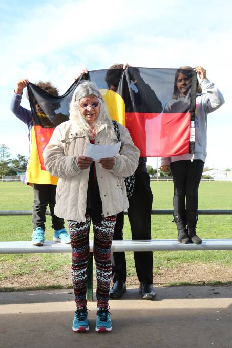 WELCOME: Elder Regina Hood opens NAIDOC Week at Dudley Cornell Park with the help of Jandamurra Lauricella, 6, of Dimboola, Jeremy Newell of Horsham and Colby McDonald, 9, of Horsham. Picture: THEA PETRASS
