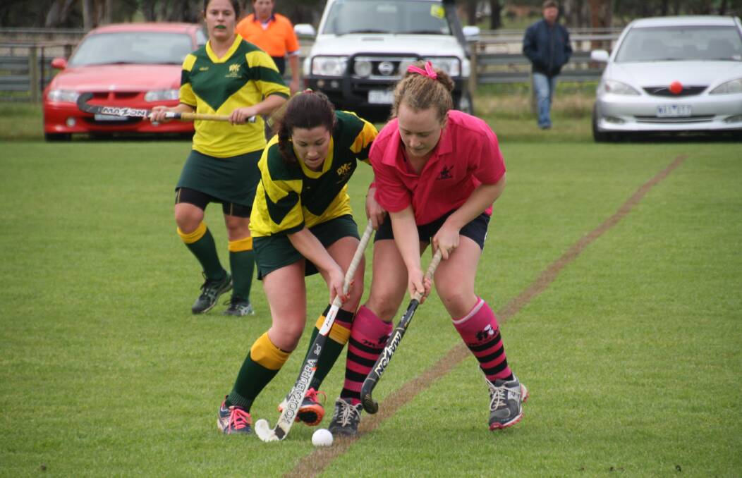 HEAD TO HEAD: Dimboola Women's Annabel askin, left, and Yanac Women's Louise Bone vie for the ball during their sides' top-two clash at Yanac on Saturday. Yanac teams wore pink shirts and black striped socks to support the McGrath Foundation's Pull On Your Socks campaign. Picture: RACHEL CLARK