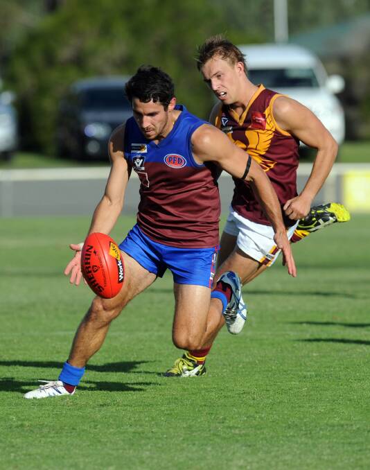 CHASE: Demon Joel Geue gets away from Eagle Jake Peters during their round one match. Picture: PAUL CARRACHER