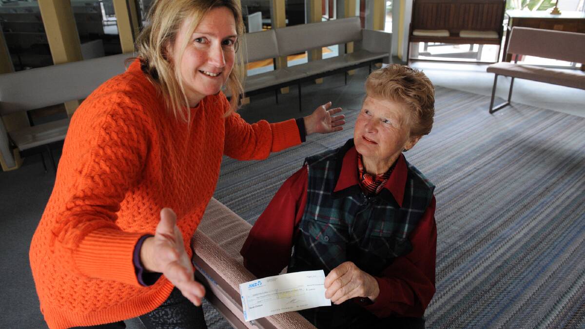 CURTAIN CALL: Wimmera Entertainer Network president Jenny Payne donates the disbanded group's money and assets to Dooen Public Hall committee representative Kola Kennedy. Picture: PAUL CARRACHER