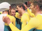 ALL SMILES: Cycling Australia’s men’s track endurance coach Tim Decker, second from the left, celebrates with gold-medal winning pursuit cyclists at the 2014 Commonwealth Games in Glasgow late last month. Picture: GETTY IMAGES
