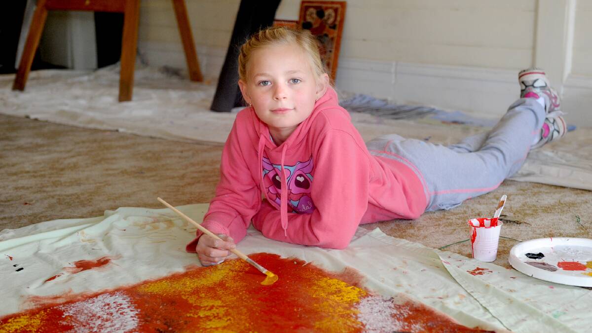 BURNT PUB: Chloe Baker, 9, of Dimboola paints a canvas for a pop-up mural at the
Dimboola Hotel. Picture: SAMANTHA CAMARR 