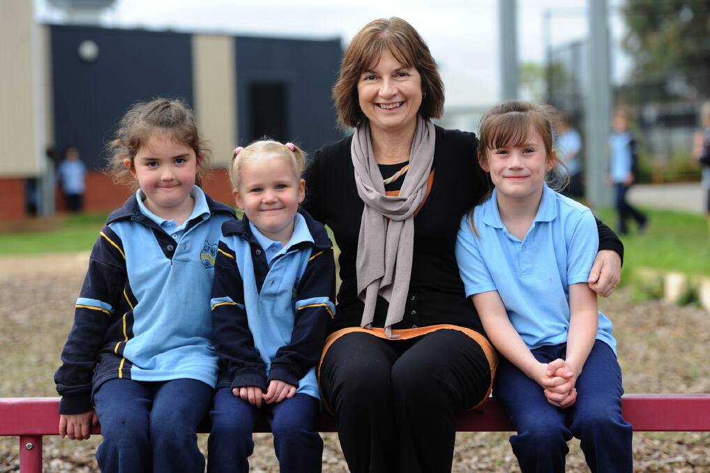 FINAL TERM: Nhill College principal Leonie Praetz with prep students Charlotte Donnell, 5, and Mia Seymour, 5, and grade two student Natalie Hall, 7. Ms Praetz is retiring after a long career in education. Picture: MELINDA SCHMIDT