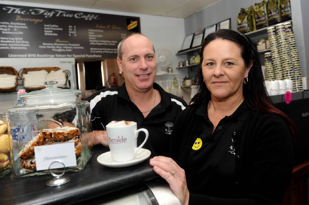 COFFEE FOR A CAUSE: Fig Tree Caffe owners Brad and Charmaine Koenig prepare a coffee for CafeSmart. A dollar from each cup of coffee sold at Cafe Chickpea, Cafe Jas and Fig Tree Caffe  on Friday was donated to programs tackling homelessness. Picture: SAMANTHA CAMARRI