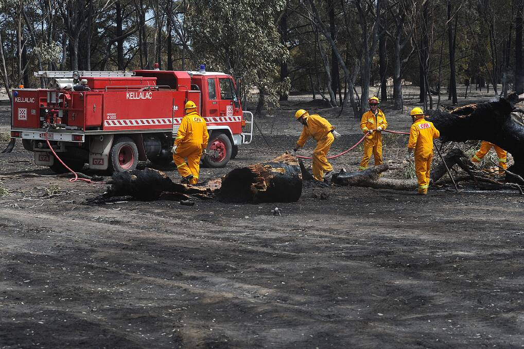 BLACK SATURDAY: Fire crews work on blacking out near Plozzas Road on February 8.