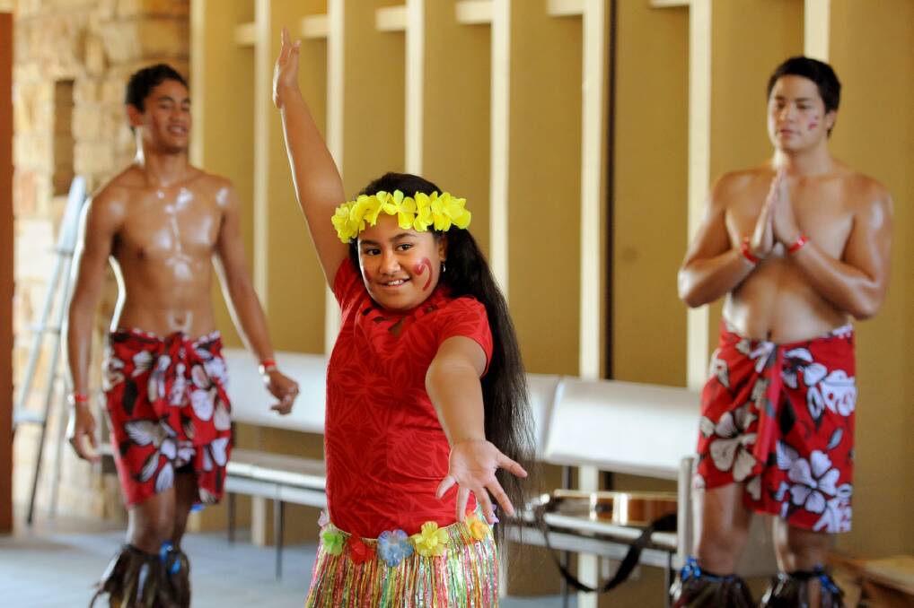 ISLAND NIGHT: Catherine Ioelu dances at a Horsham Uniting Church Pacific Island event on Saturday night, while Sanele Muliaga and Christian Tupai look on. The church hosted a dinner and show to raise money for mission activities in the region. The fundraiser featured Pacific Island cuisine and culture.