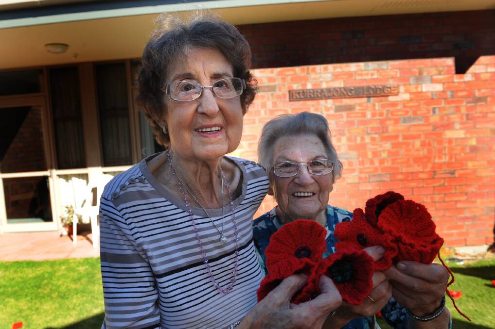 Kurrajong Lodge residents Doris Matthews and Edna Elliott with poppies knitted to represent the Field of Flanders. Mrs Matthew’s husband Jack had a nephew, Alex Cameron, in the war. Mrs Elliott’s brother Clarrie Albrecht was also in the war.  Lodge residents, friends and family members knitted 763 poppies for Anzac Day. Picture: PAUL CARRACHER