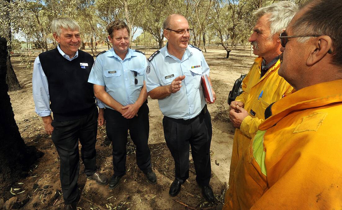 BLACK SATURDAY: Department of Sustainability and Environment fire controller Geoff Evans, CFA operations manager Dale Russell and CFA chief officer Russell Rees chat with volunteers Colin Warrick and John Davies.