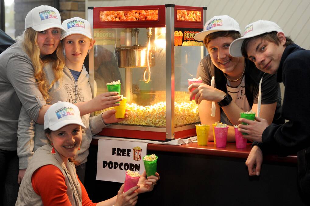 POP UP FUN: The Harvest Church Youth Group members Marisha and Normie Arnold, Ruth Emmerson, Greg McKinnon and Tait McMarth practise their popcorn cooking skills for the Operation 19:14 Free Family Fun Day. Picture: SAMANTHA CAMARRI