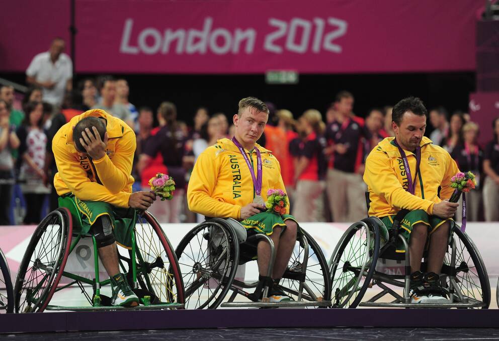 Jannik Blair, centre, after winning silver at the London Paralympic Games in London. He described the feeling of coming second as gutting. Picture: GETTY IMAGES