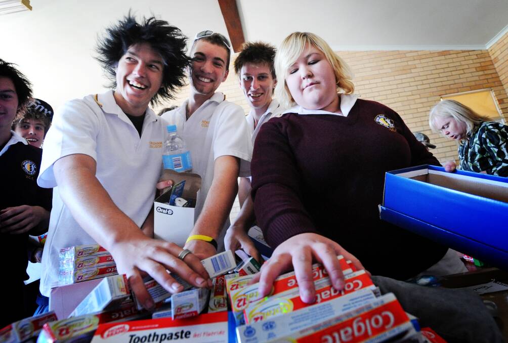 BLACK SATURDAY: Horsham College year 11 students Lee Johnston, Lachlan Trigg, Aace Hood-Hunter and Katelyn McKay work on getting boxes of relief supplies together. Picture: TIM HESTER