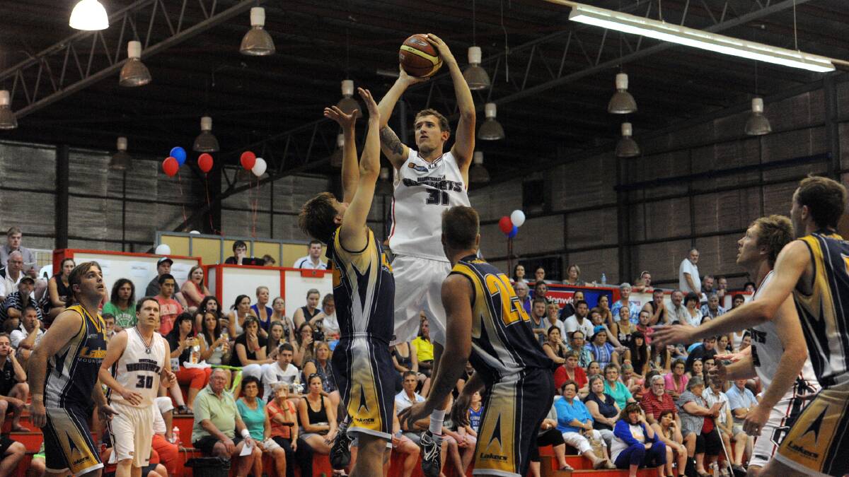 ELEVATION: Jon Schwarz rises for a jump shot over two Mount Gambier opponents.