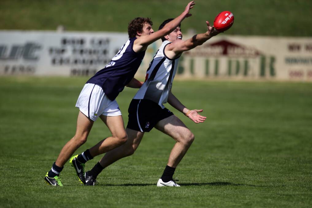 Rebel Keegan Mason tries to marks over Falcons player Zaine Cordy. Picture: DAMIAN WHITE