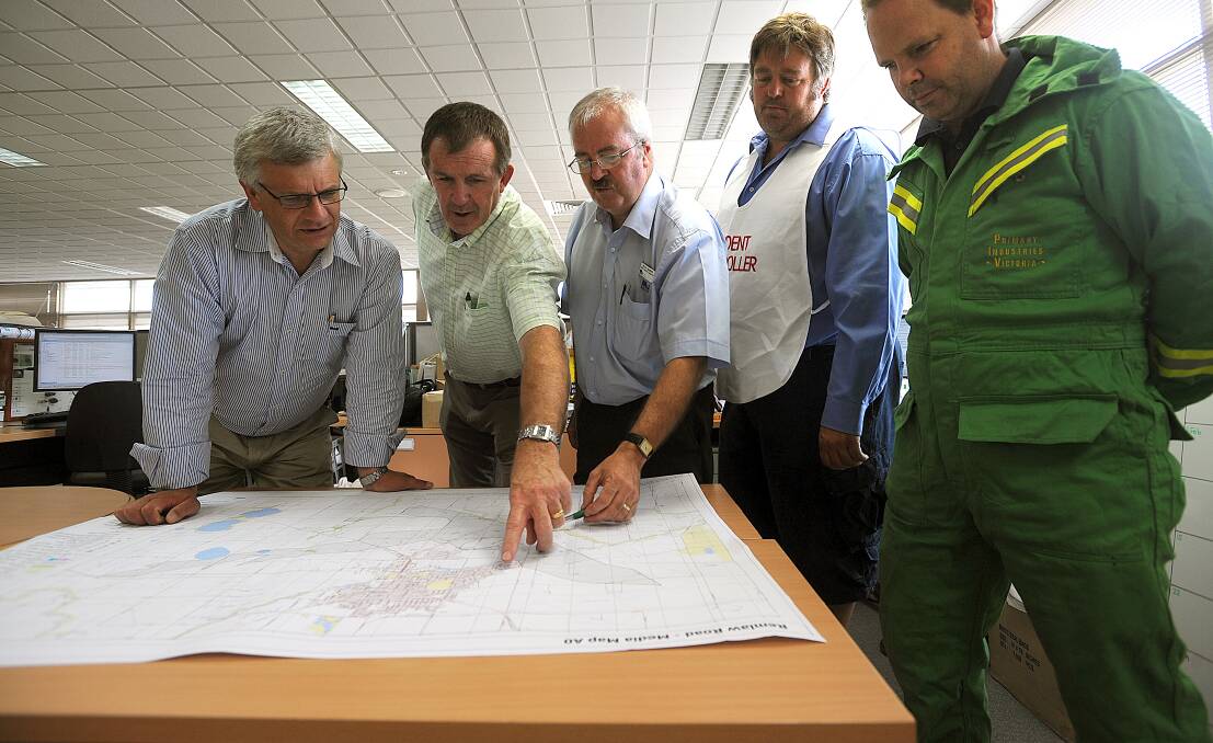 BLACK SATURDAY: Member for Ripon Joe Helper, Member for Lowan Hugh Delahunty, Department of Primary Industries' Bruce Taberner, incident controller Chris Souness and the department's Paul Beltz track the path of the fire.