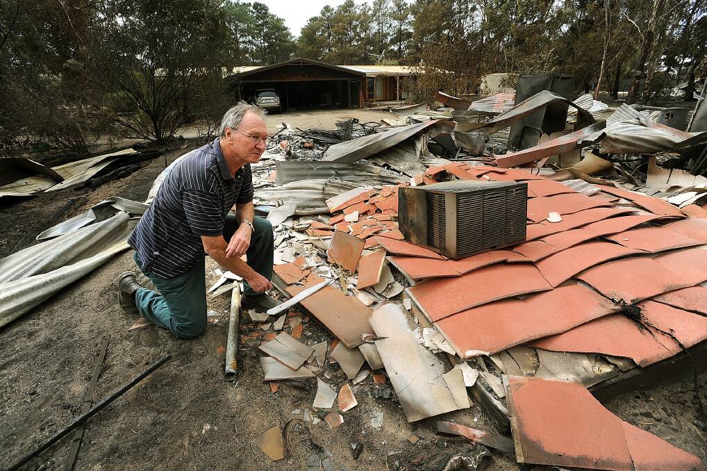 BLACK SATURDAY: Haven's Peter Rafter surveys the remains of his home in Haven.