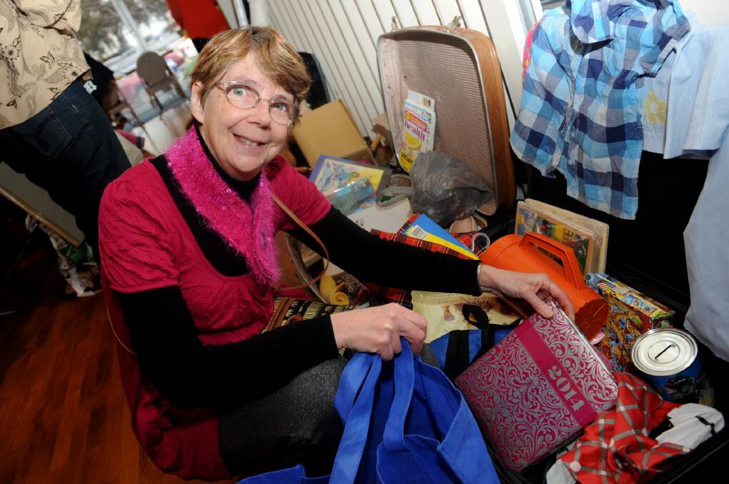 
RUMMAGE FOR REFUGEES: Horsham woman Shirley McMartin sifts through offerings at A Case for Kindness suitcase rummage on Saturday. Picture: SAMANTHA CAMARRI