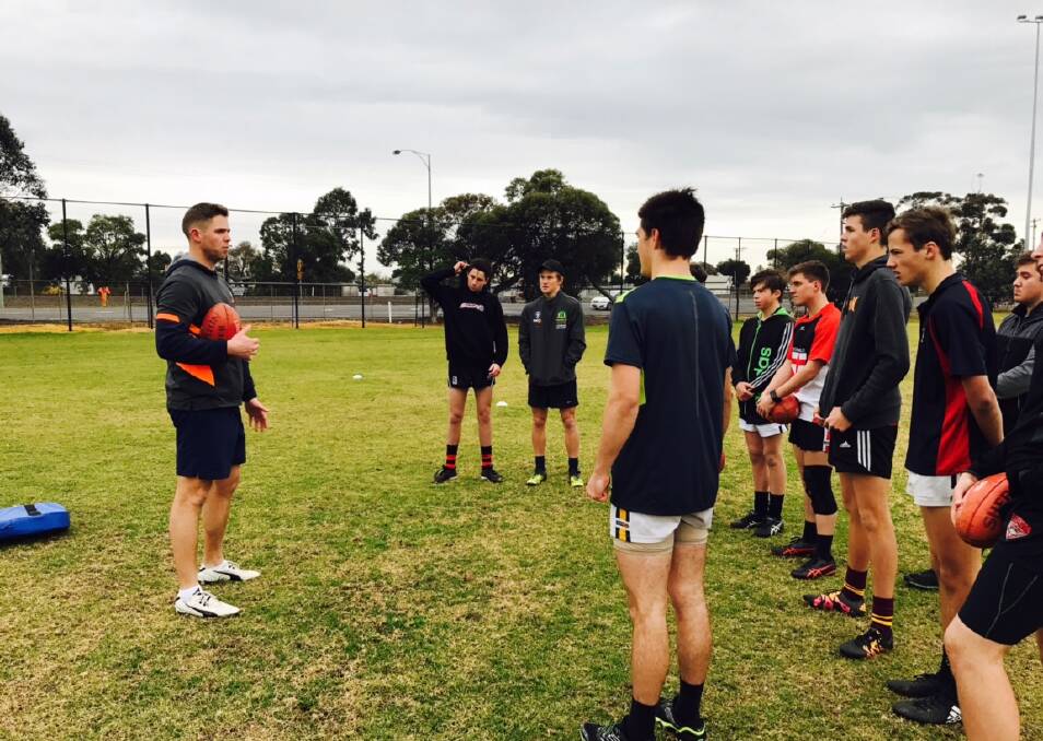 COACH: Luke O'Shannessy instructs young Wimmera footballers on some of the fundamentals of the game at the intensive session. Pictures: CONTRIBUTED
