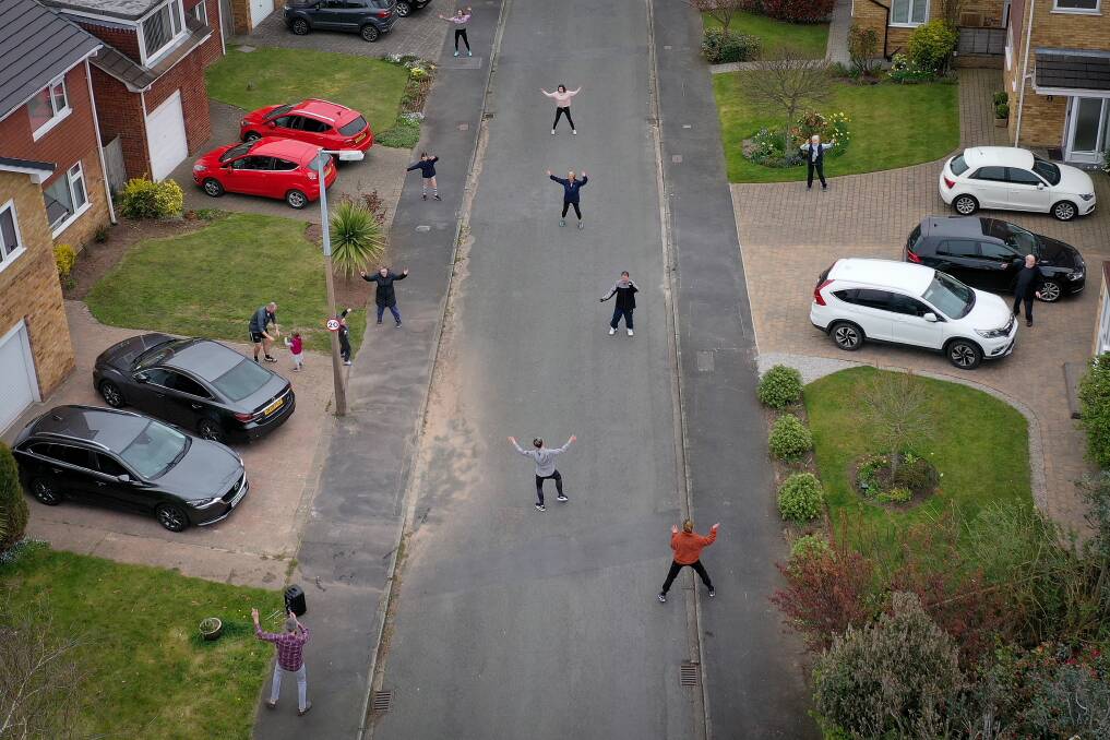 Residents Cheshire, England, take part in their daily social distance dancing and fitness event, led by resident Janet Woodcock during the pandemic lockdown. Photo: Getty Images
