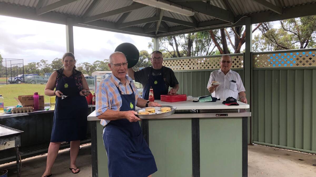 The Haven Tennis Club cooking bacon and egg muffins at the market. Picture: contributed
